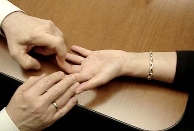 Manual muscle testing of long finger FDP flexor tendon.